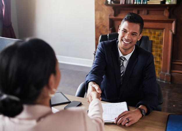 Photo lawyer man handshake and client meeting in office of court administration legal advice and deal happy attorney shaking hands in consultation business success or thank you of negotiation agreement