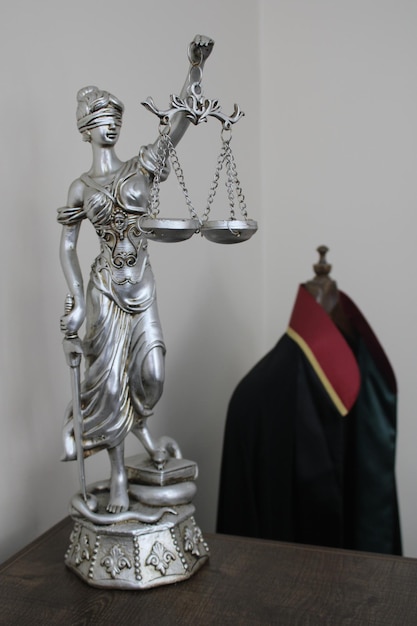 lawyer robe and statue of a woman symbolizing justice and law justice and scales