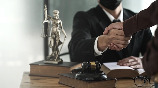 Lawyer shakes hands with employer after winning lawsuit.