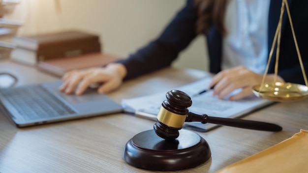 Lawyer signing important legal document on desk at office