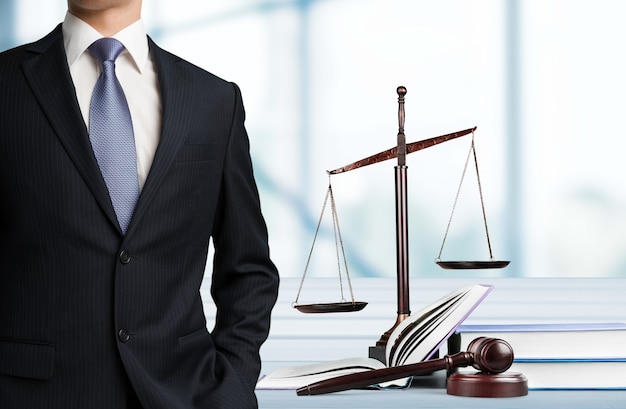 Lawyer standing near Scales of Justice on the background