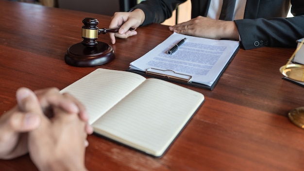 Lawyer working with client discussing about legal legislation in courtroom