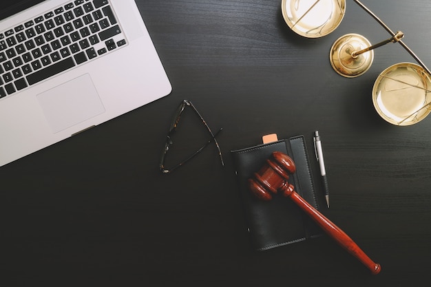 Photo .lawyer workplace with laptop and documents with dark wooden