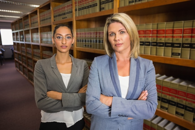 Lawyers looking at camera in the law library