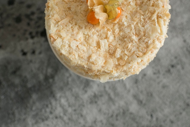 Layered cake on a plate decorated with physalis