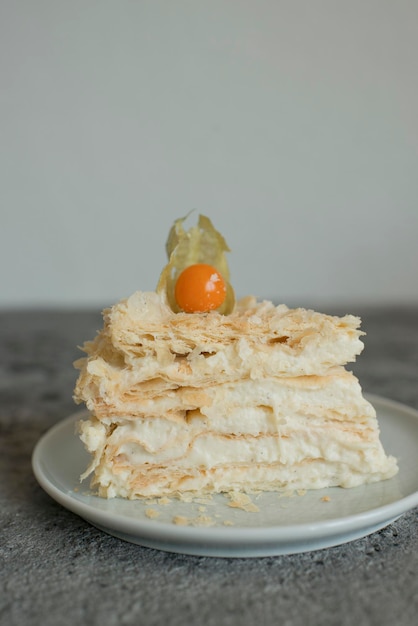 Layered cake on a plate decorated with physalis