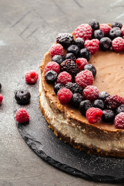 layered cheesecake decorated with berries