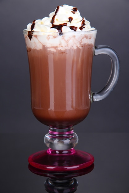 Layered coffee in glass on table on grey