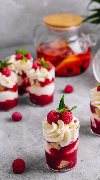 layered dessert trifle with vanilla cake whipped cream and fresh raspberries