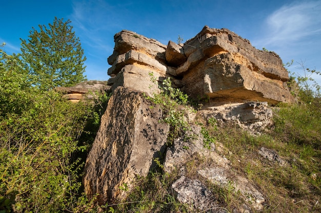 Layered rocky ledge of sandstone rock, natural ledge, Ukraine, Medobory, Ternopil region