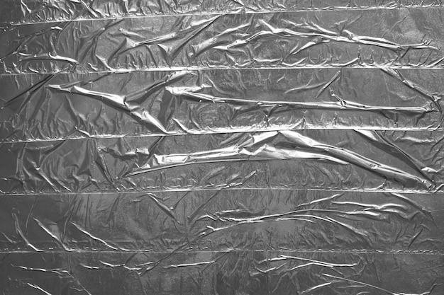 Фото Многослойная серебряная клейкая лента фоновой текстуры