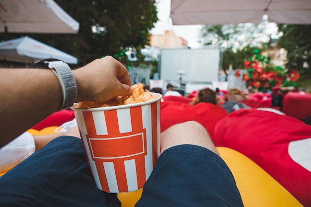 Laying eating snacks watching movie at open air cinema