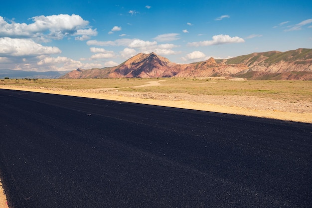 Photo laying of new black asphalt renovation of the expressway and the highway outside the city