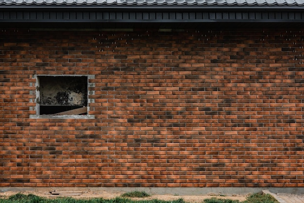 Laying the tiles in the form of brick on the wall outside.