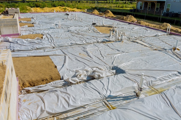 Laying in the a trench ground PVC pipes before pouring concrete