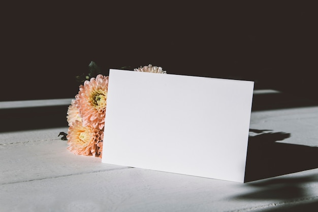 Photo layout of an empty postcard and flowers