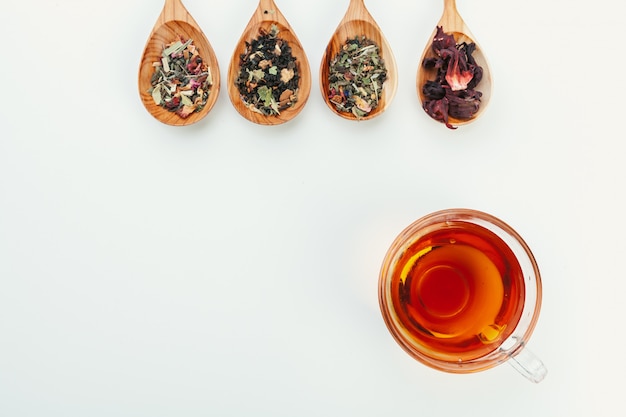 layout made of cup of black tea and leaves on a white background. Top view