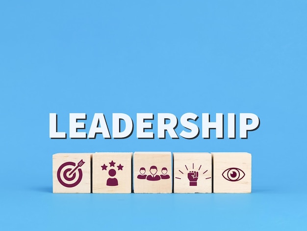 Leadership concept with icons on wooden cubes against blue background.