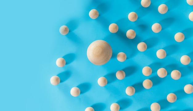 Leadership concept, Wooden ball with shadow on blue background