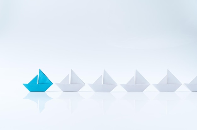 Leadership conceptual using blue paper ship