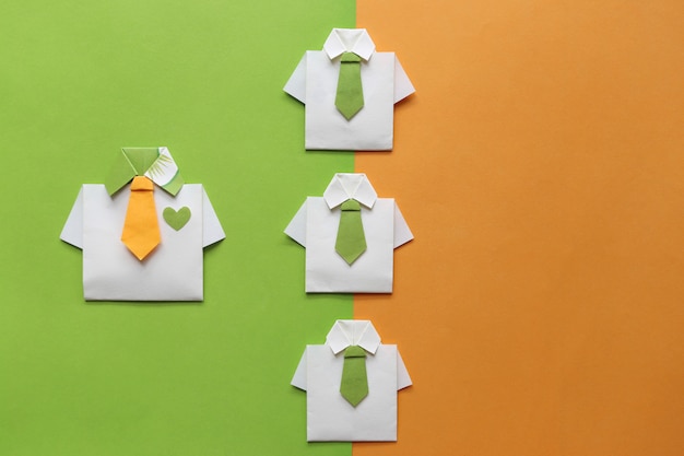 Leadership and teamwork concept, Origami yellow shirt with tie and leading among small yellow shirt