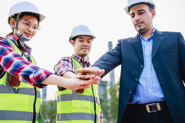 Leadership Teamwork engineer and businessman standing on power plant Construction project