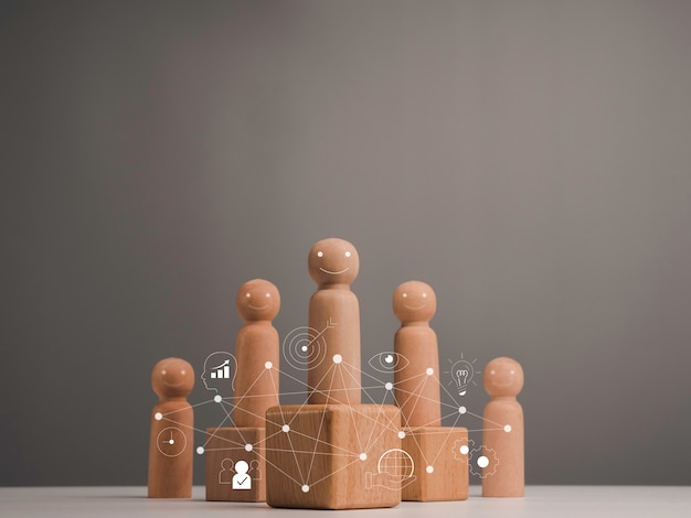 Leadership with business strategy and key to success concept. Wooden figure, leader with influence and empowerment standing on the box and team and business management vision icons, minimal style.