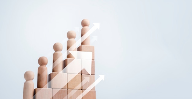 Leadership with business success concept. Modern rising up arrows and wooden figures standing on a growth graph chart step arranged by wood cube blocks isolated on white background with copy space.