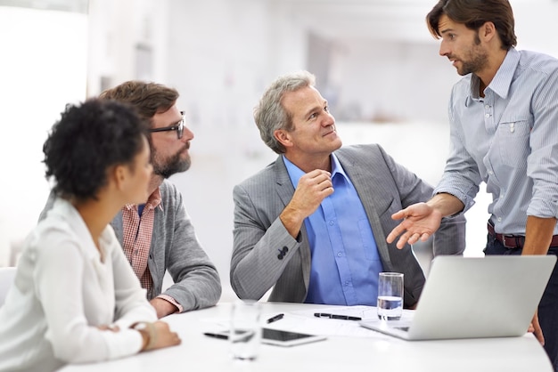 Leading his team through the creative process. Shot of a group of a diverse group of business professionals having a meeting.