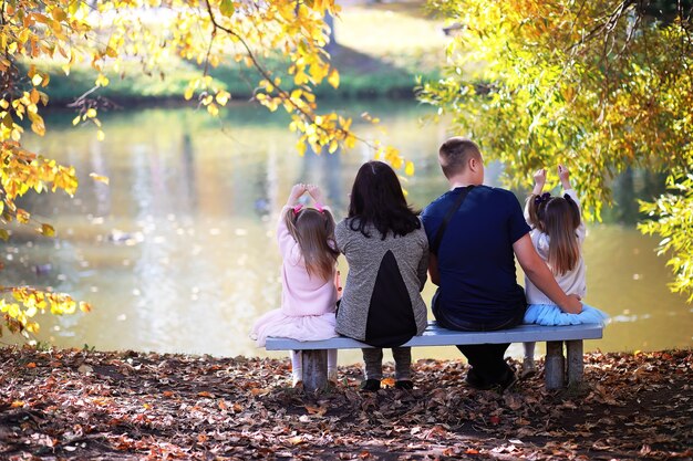 Leaf fall in the park. Children for a walk in the autumn park. Family. Fall. Happiness.