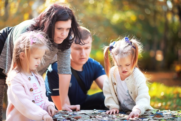 Leaf fall in the park. Children for a walk in the autumn park. Family. Fall. Happiness.