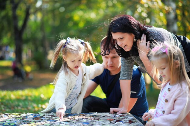 Leaf fall in the park. Children for a walk in the autumn park. Family. Fall. Happiness.