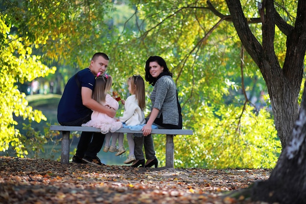 Leaf fall in the park. Children for a walk in the autumn park. Family. Fall. Happiness.