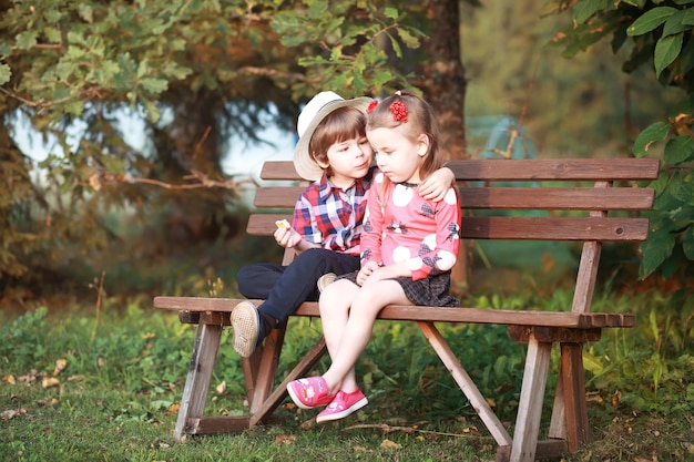 Leaf fall in the park. Children for a walk in the autumn park. Family. Fall. Happiness.