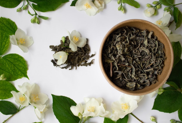 Leaf tea with jasmine in a round carton on white background zero waste concept