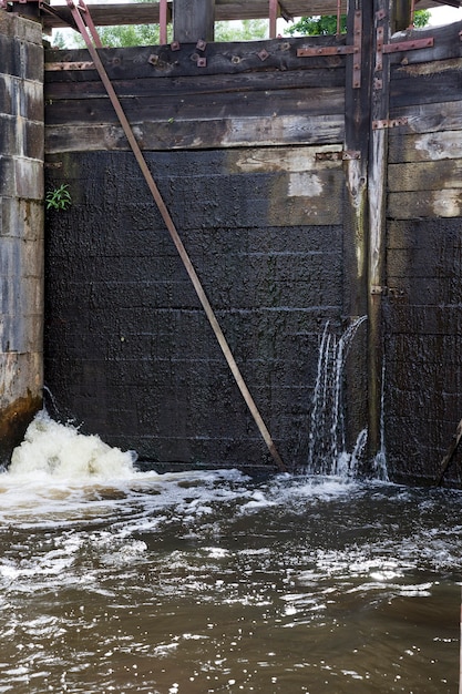 A leaking part of an old wooden dam