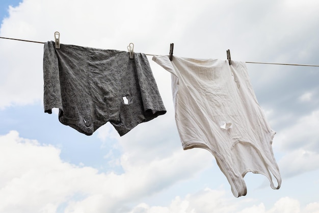 Photo leaky tshirt and panties on a clothesline against the sky poverty concept