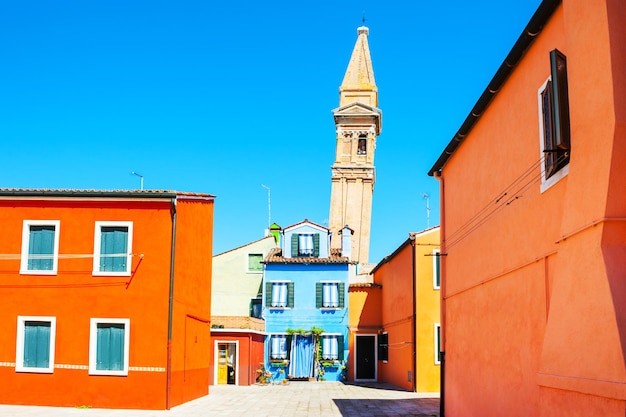 Leaning bell tower and colorful houses in Burano island near Venice, Italy