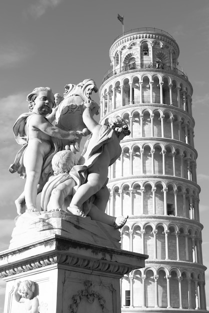 The Leaning Tower of Pisa and La Fontana dei Putti Statue, Italy. Black and white image