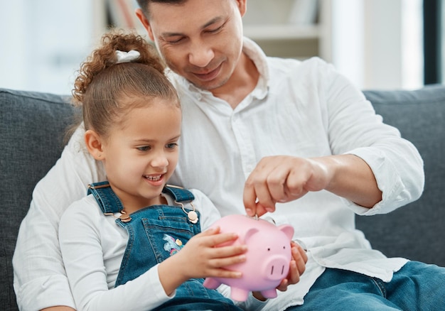 learning dad and child with piggy bank or smile for savings budget or coins in family home development father or girl kid holding moneybox for teaching financial freedom education or investment