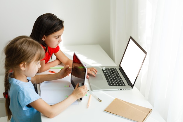 Premium Photo | Learning from home, home school kid concept. little children study online learning from home with laptop. quarantine and social distancing concept. Premium Photo | Learning from home, home school kid concept. little children study online learning from home with laptop. quarantine and social distancing concept.