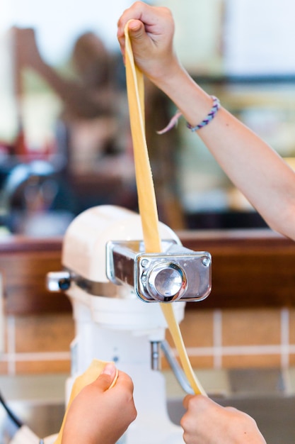 Learning how to make fresh spaghetti from scratch.