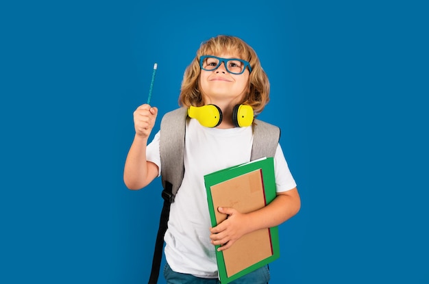 Learning knowledge and kids education concept School teen boy in with backpack Thinking pensive kids thoughtful emotions of school child clever smart funny nerd have idea