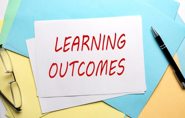 learning outcomes text on paper on colorful paper background