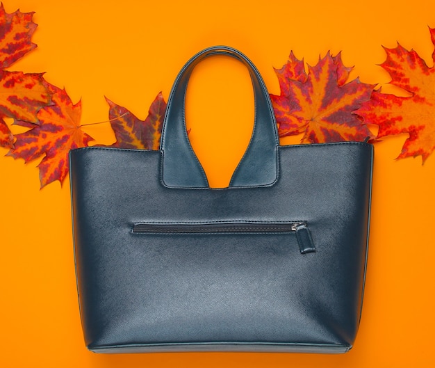 Leather bag of fallen autumn leaves