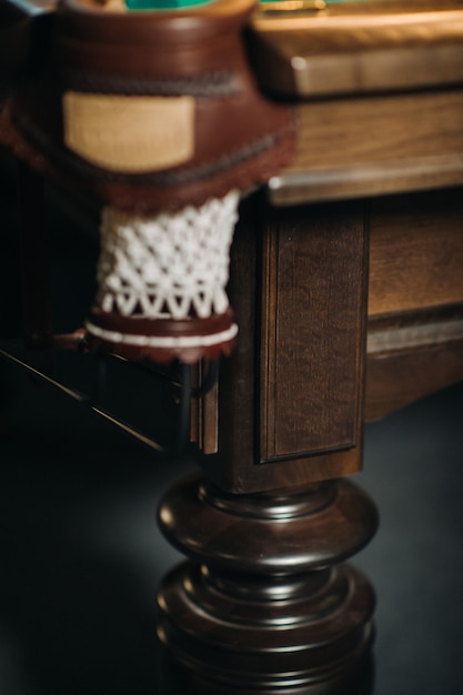 Leather billiard hole and table leg in a billiard club.