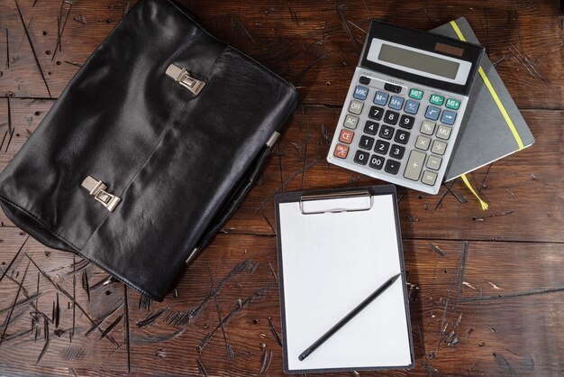 Leather briefcase and calculator working tablet and pencil workbook and calculator diary for records