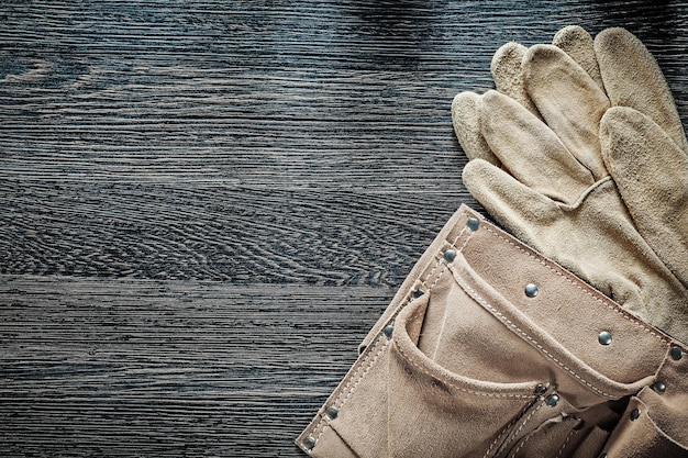 Leather building belt pair of protective gloves on black board