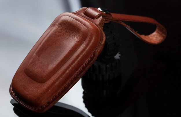 Leather case for car keys on a black background