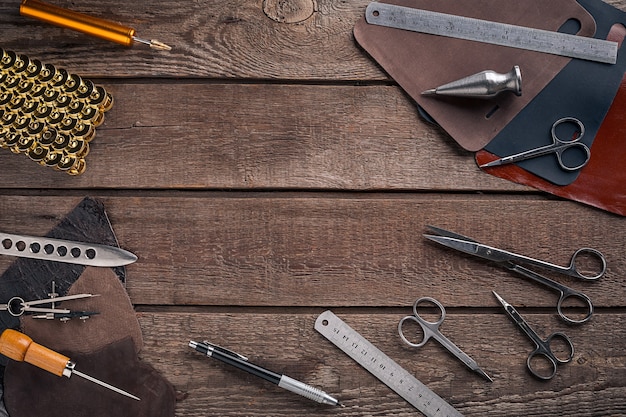 Leather craft or leather working leather working tools and cut out pieces of leather on work desk